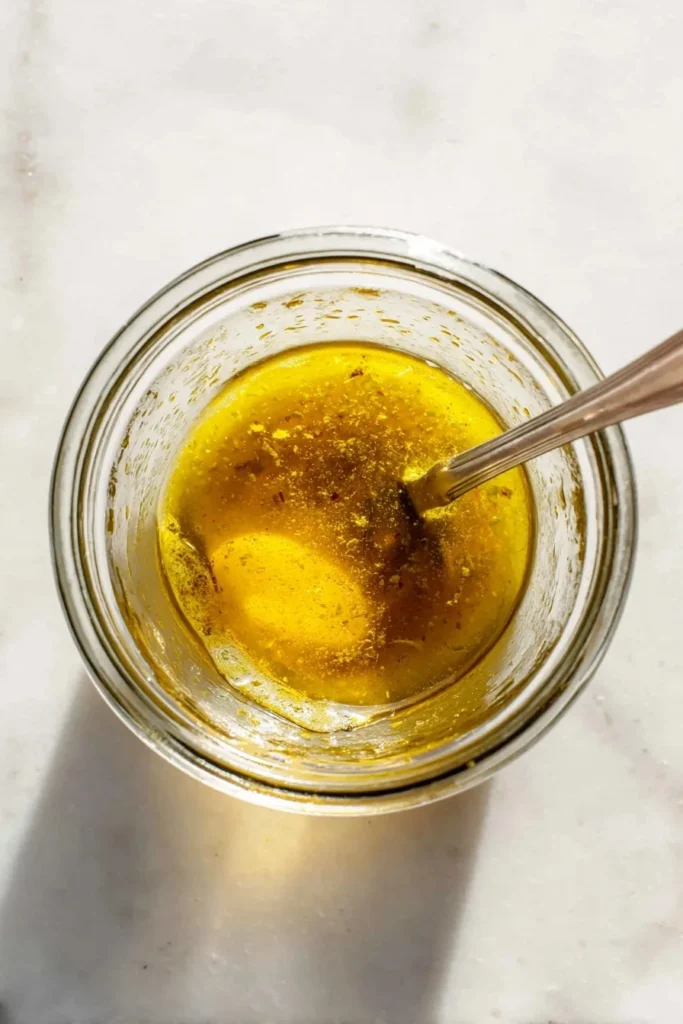 Whisking vinaigrette dressing for kale salad with berries