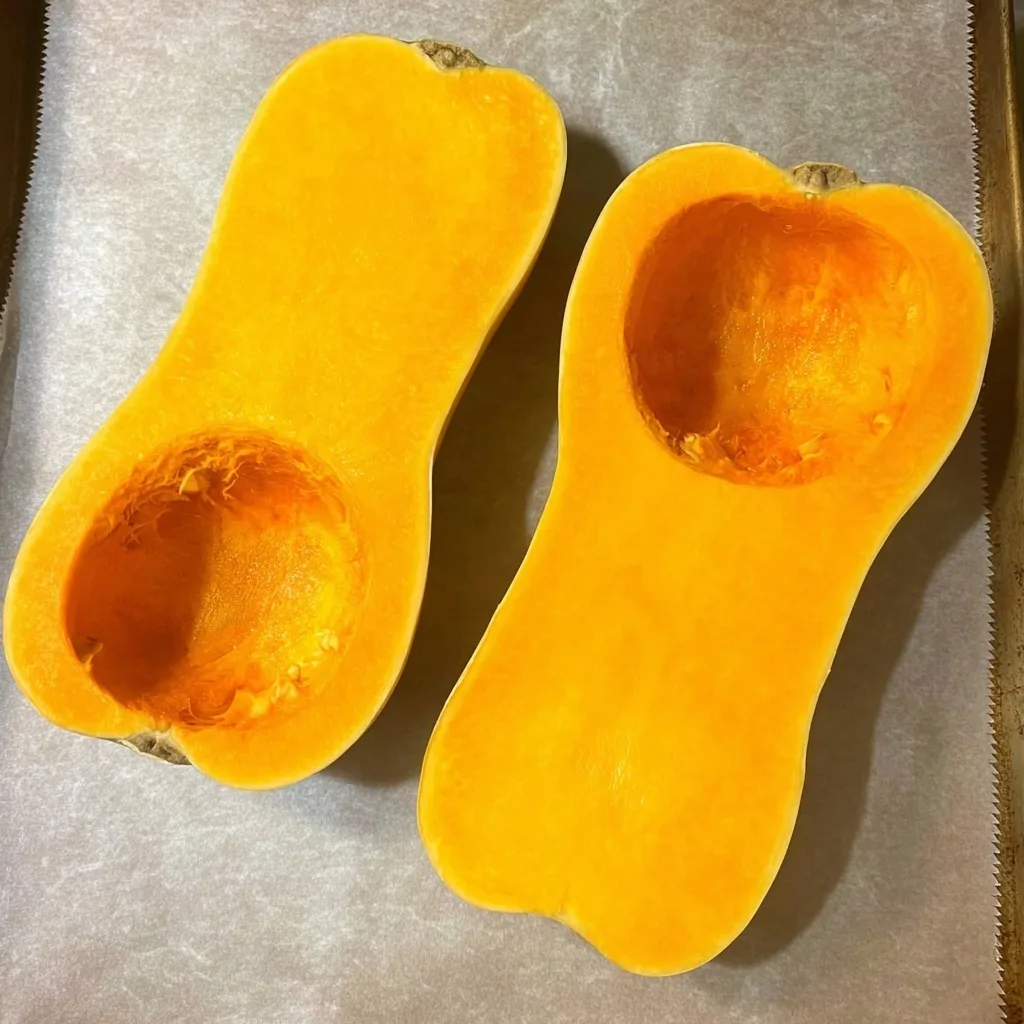 Fresh butternut squash cut in half and scooped out, ready for roasting