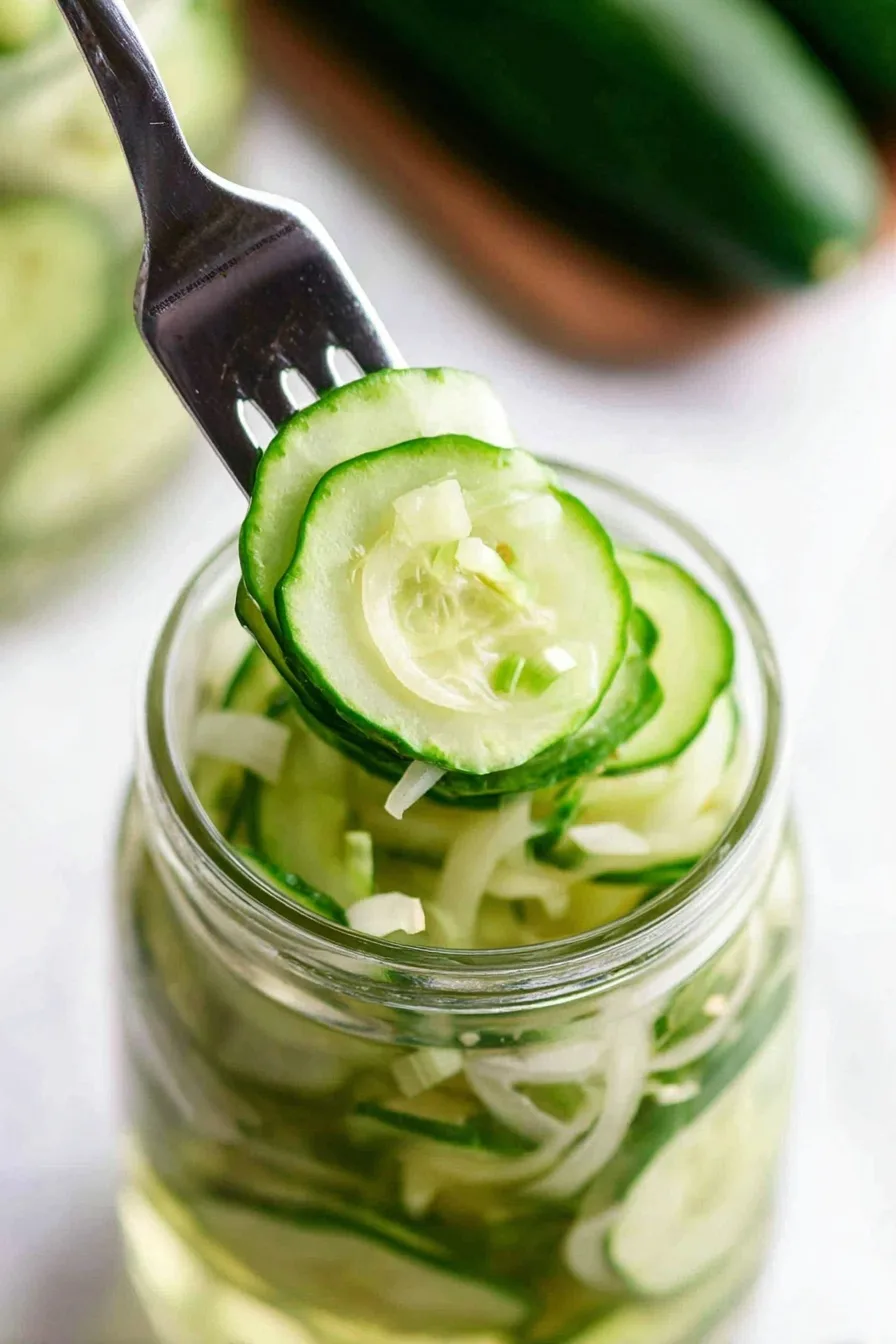 Close-up of easy refrigerator pickles with cucumbers and onions on a fork