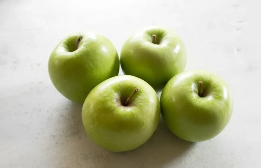 Fresh green apples on a white background for baking apple muffins.