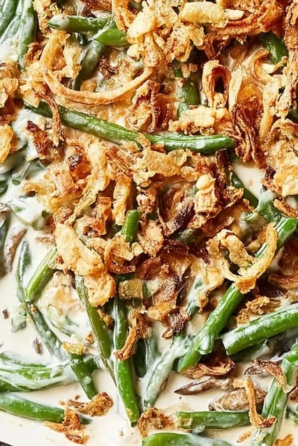Baked green bean casserole with creamy sauce and crispy fried onion topping, fresh out of the oven.