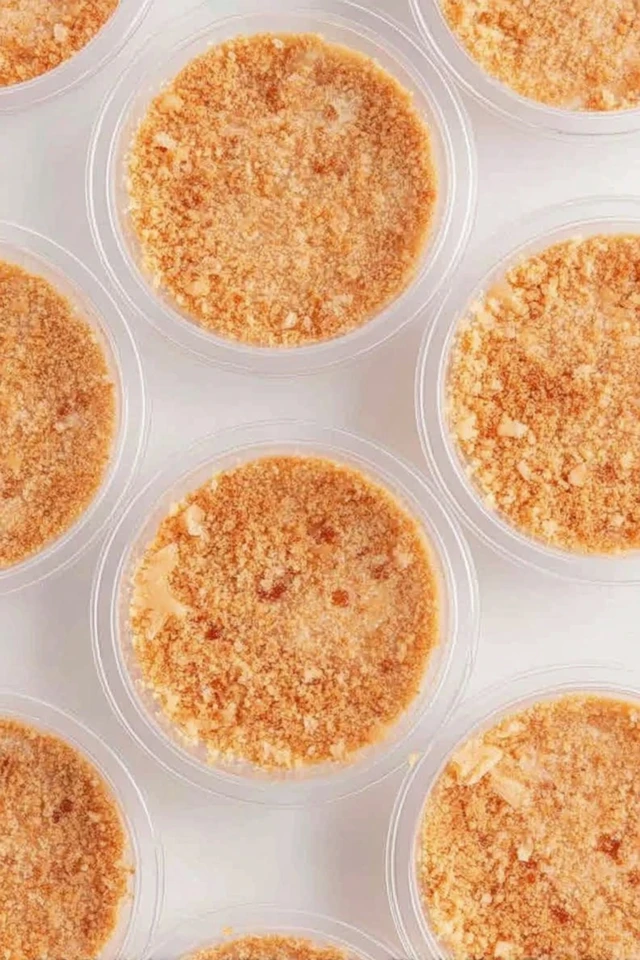 Caramel apple dessert cups topped with a crumb layer in clear plastic cups viewed from above