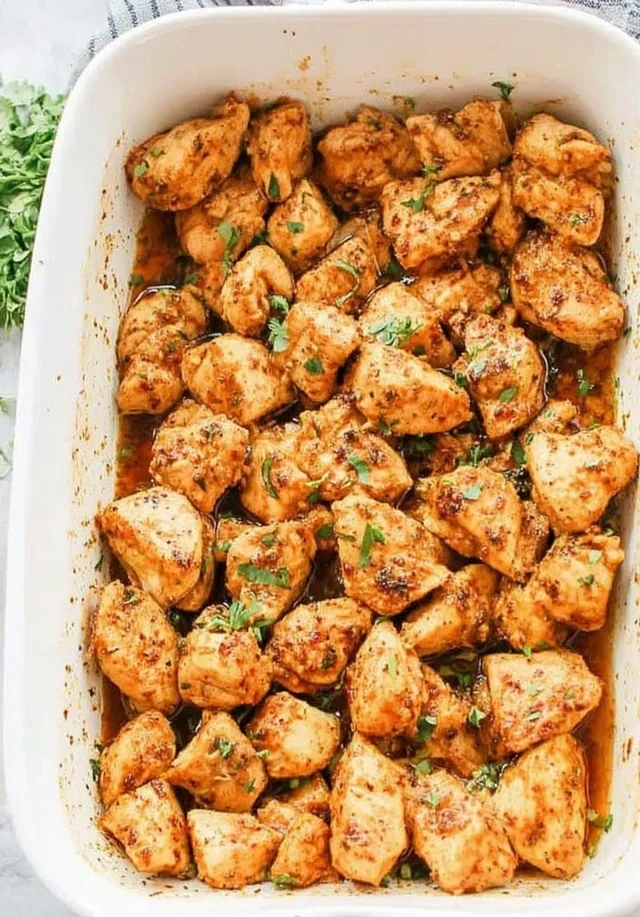 Golden oven-baked chicken bites seasoned with spices and herbs