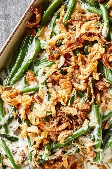 Easy green bean casserole baked with creamy sauce, tender green beans, and crispy fried onion topping.