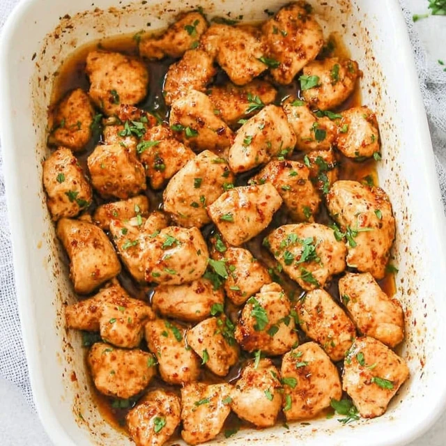 Juicy oven-baked chicken pieces with herbs in a baking dish