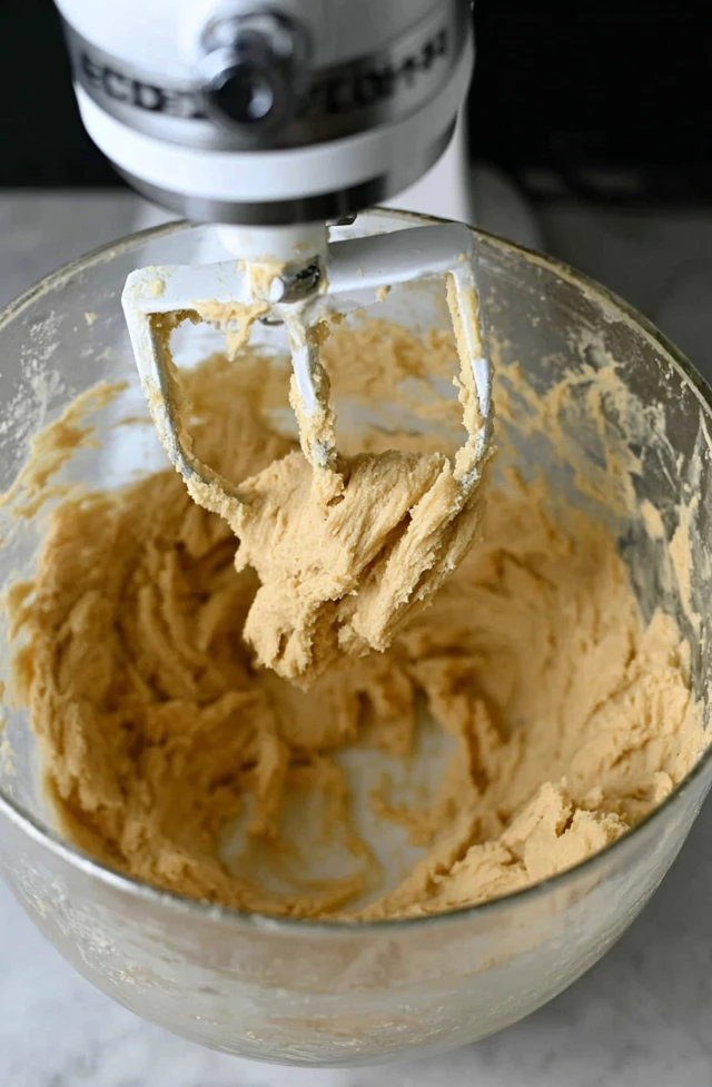 Cranberry bliss bars batter being mixed in a stand mixer bowl