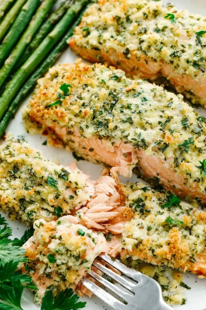 Parmesan crusted salmon with flaky texture served alongside roasted green beans
