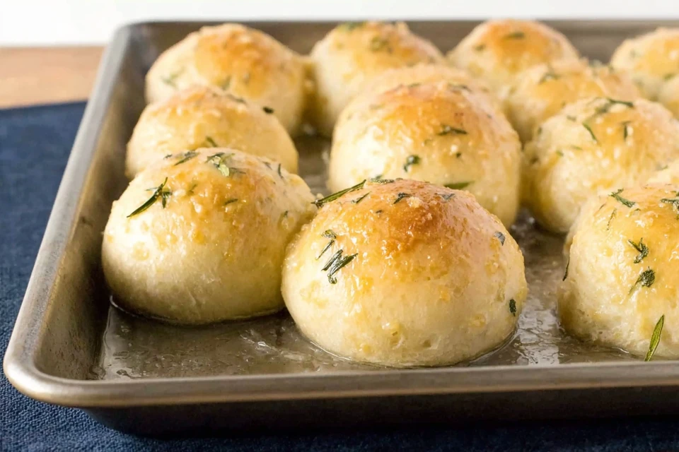 Garlic Butter Cheese Bombs baking on a tray, golden and brushed with garlic butter