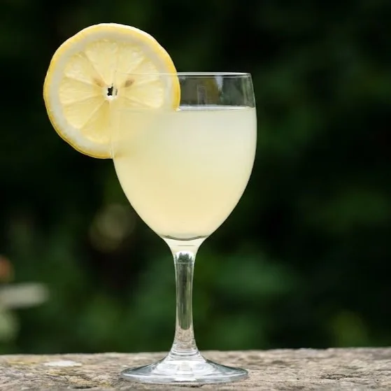 Homemade ginger lemonade served in a glass with fresh lemon slice garnish