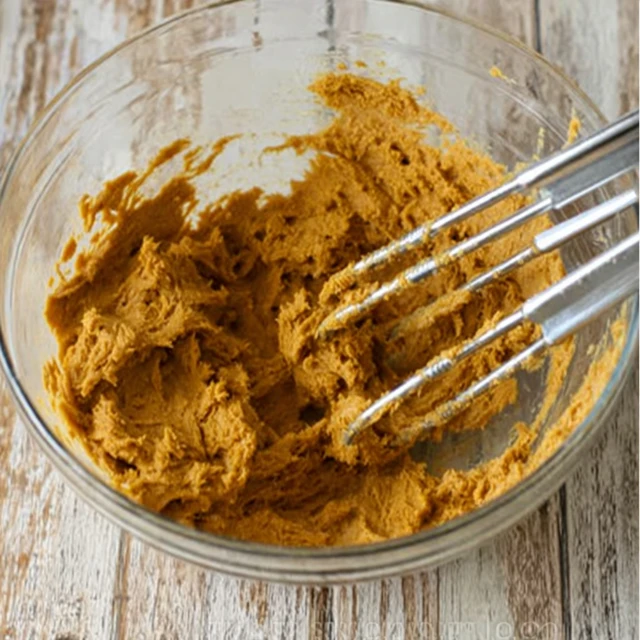 Soft gingerbread cookie dough fully mixed and ready to chill in a glass bowl