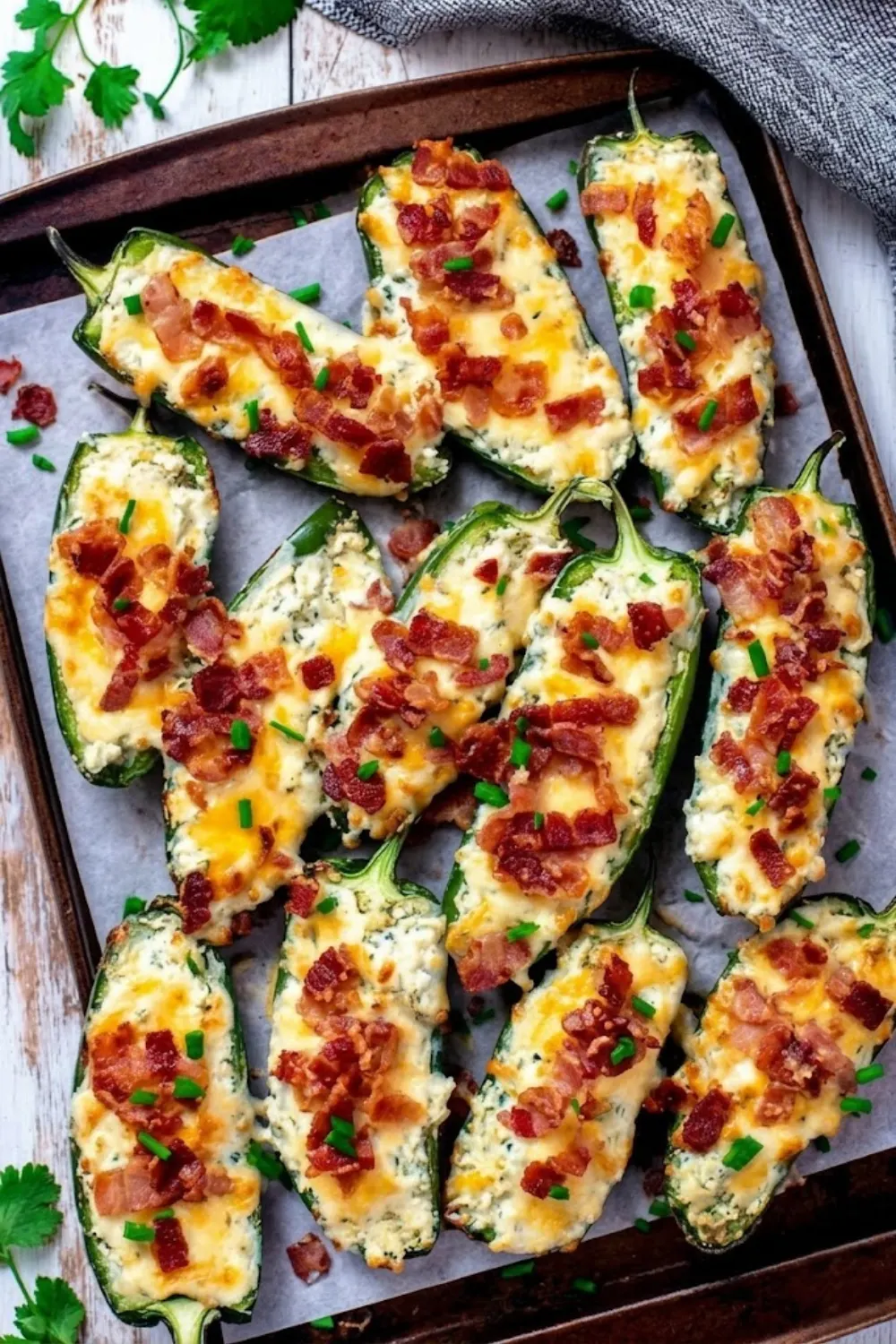 Keto Jalapeno Popper Bites baked with melted cheese and crispy bacon on a baking tray